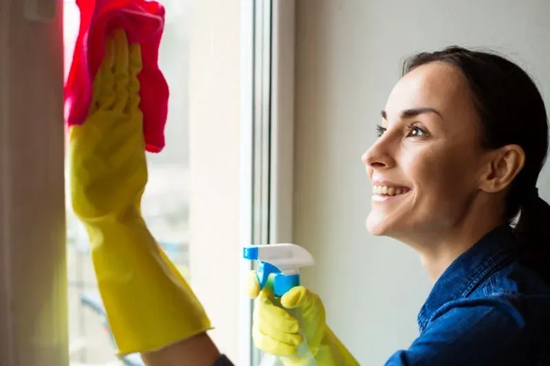 Cleaning double-hung windows in Milwaukee, WI home by Empire Home Remodeling window installers